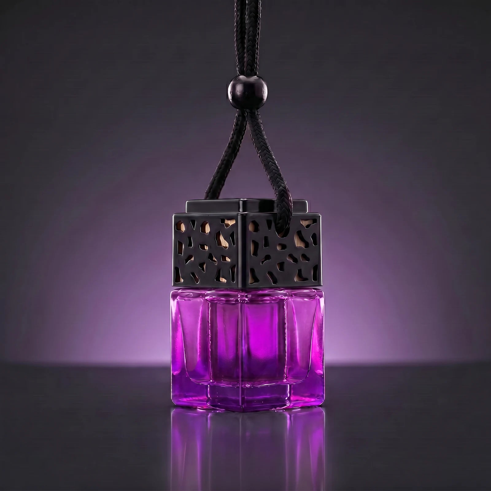 Purple FRESURE car diffuser — vivid purple glass cube bottle with black lattice cap on a dark studio background