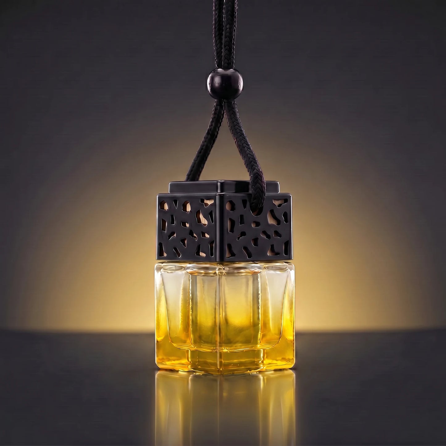 Yellow FRESURE car diffuser — golden yellow tinted glass cube bottle with black lattice cap on a dark studio background