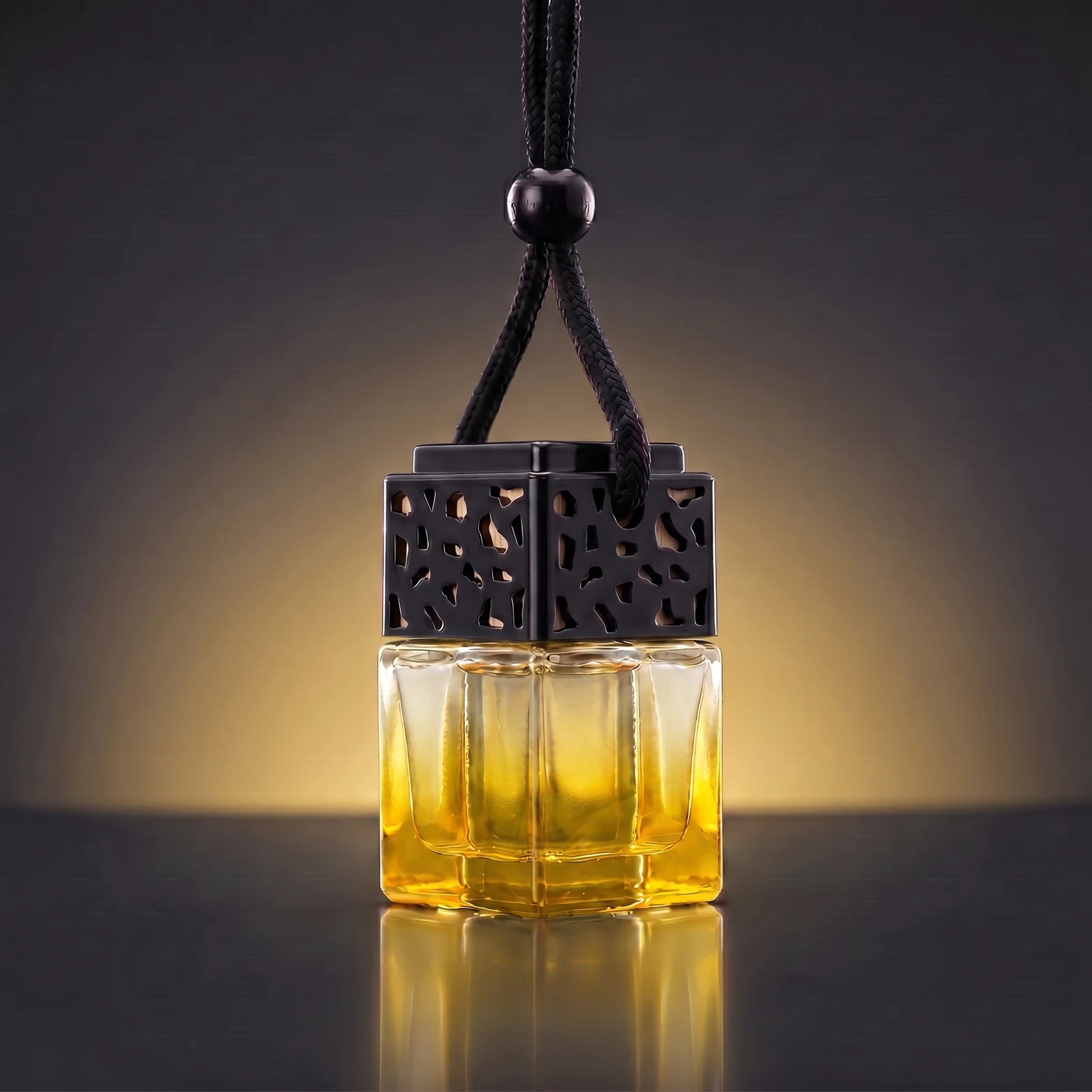 Yellow FRESURE car diffuser — golden yellow tinted glass cube bottle with black lattice cap on a dark studio background